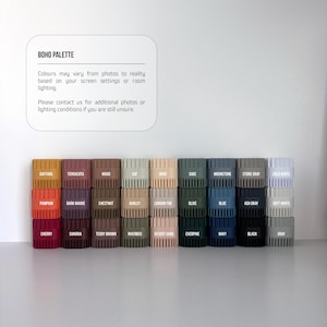 a collection of various colored plastic containers or bins arranged in a row, likely representing different colors or shades of a particular material or product.