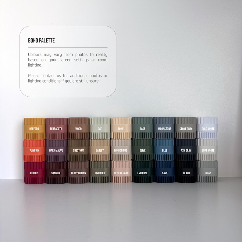 a collection of various colored plastic containers or bins arranged in a row, likely representing different colors or shades of a particular material or product.