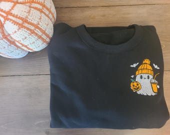 Embroidered sweatshirt with a fall theme, featuring a ghost clutching a coffee cup, perfect for autumnal coffee enthusiasts.