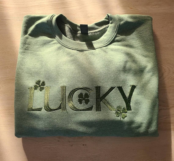 Embroidered Lucky Sweatshirt. Lucky logo with 4 leaf clover, available in green/green stitch or white/ green stitch. Irish blessing