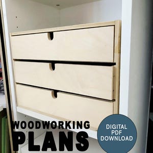 May include: Three wooden drawers with a simple design, built into a white cabinet. The drawers are made of light wood and have a smooth finish. The text "WOODWORKING PLANS DIGITAL PDF DOWNLOAD" is visible at the bottom of the image.
