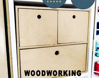 May include: Woodworking plans for a three-drawer cabinet with a light wood finish. The plans are digital and available for download. The cabinet has three drawers with round cutouts for handles. The text "WOODWORKING PLANS" is printed in black on a white background.
