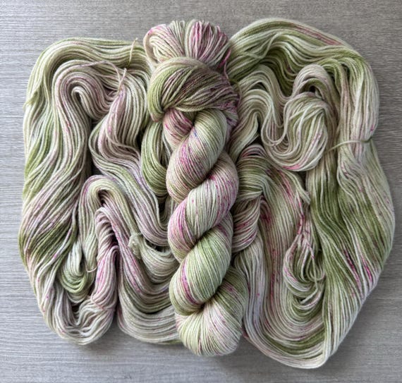 hand dyed variegated yarn sock yarn fingering weight yarn super wash merino wool yarn green tonal yarn purple speckled yarn for knitting