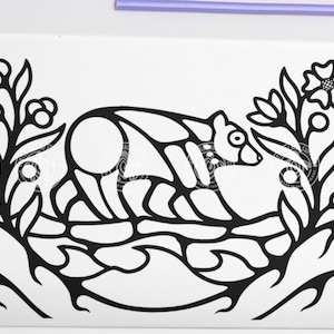 May include: Black and white line art illustration of a bear walking through a field of flowers. The bear is stylised and has a geometric design. The flowers are simple and have a few leaves.