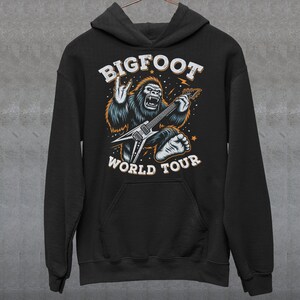 May include: Black hoodie featuring a graphic of Bigfoot playing a guitar with the text "BIGFOOT WORLD TOUR".