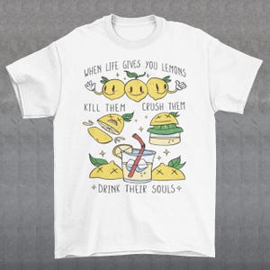 Introducing our adorable and quirky Lemonade-themed t-shirt that is sure to turn heads and bring a smile to your face! This shirt features a delightful design showcasing cute lemons being transformed into delicious lemonade, accompanied by the bold, tongue-in-cheek text: "WHEN LIFE GIVES YOU LEMONS, KILL THEM, CRUSH THEM AND DRINK THEIR SOULS."