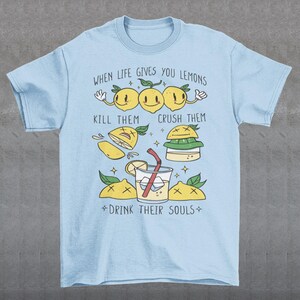 Introducing our adorable and quirky Lemonade-themed t-shirt that is sure to turn heads and bring a smile to your face! This shirt features a delightful design showcasing cute lemons being transformed into delicious lemonade, accompanied by the bold, tongue-in-cheek text: "WHEN LIFE GIVES YOU LEMONS, KILL THEM, CRUSH THEM AND DRINK THEIR SOULS."
