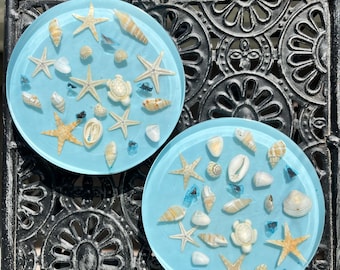 Sottobicchieri in resina con vere conchiglie e stelle marine - Set da 2