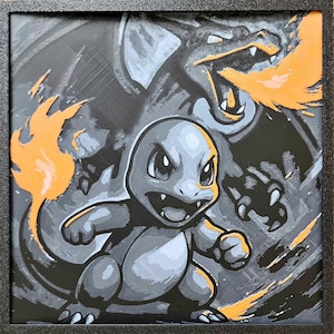 May include: Framed artwork featuring a gray Charmander with an orange flame and a gray Charizard in the background. The artwork is set against a black and gray background with orange accents, all within a black frame.