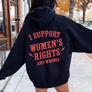 May include: Black hoodie with the text "I SUPPORT WOMEN'S RIGHTS AND WRONGS" in red. The text is centered on the back of the hoodie. The hoodie has a hood and long sleeves.