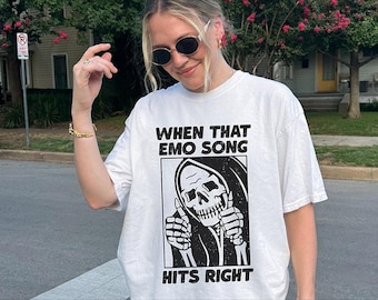 May include: White t-shirt with a black and white graphic of a skeleton with the text "When that emo song hits right".
