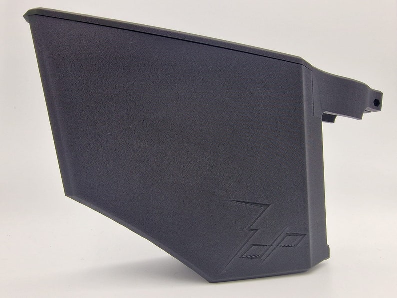 May include: A black plastic storage container with a textured surface and a lightning bolt logo. The container is designed for storing small items.