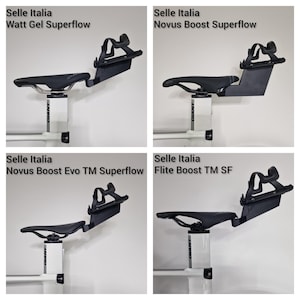 May include: Four black bicycle saddles mounted on white seat posts, each featuring a rear bottle cage attachment. The models include Selle Italia Watt Gel Superflow, Novus Boost Superflow, Novus Boost Evo TM Superflow, and Flite Boost TM SF.