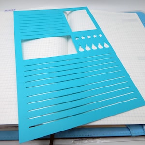 May include: A bright cyan plastic stencil sheet featuring various cutouts including horizontal lines for writing, a large rectangular box, a smaller rectangular box, a row of five star shapes, and a row of five flame-like teardrop shapes.
