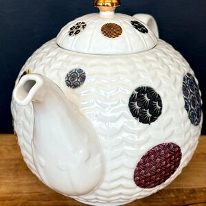 May include: A set of three ceramic vases in varying heights. The vases are white with a textured, ribbed design. The tallest vase is approximately 10 inches tall, the medium vase is 8 inches, and the smallest is 6 inches.