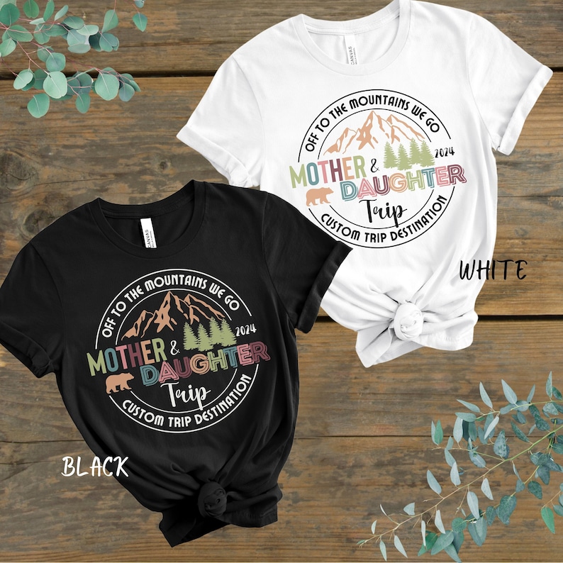 Mother and daughter trip shirts adorned with a mountain scene, personalized with trip destination.