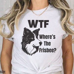 May include: White t-shirt with a black and white border collie dog illustration and the text "WTF Where's The Frisbee?"