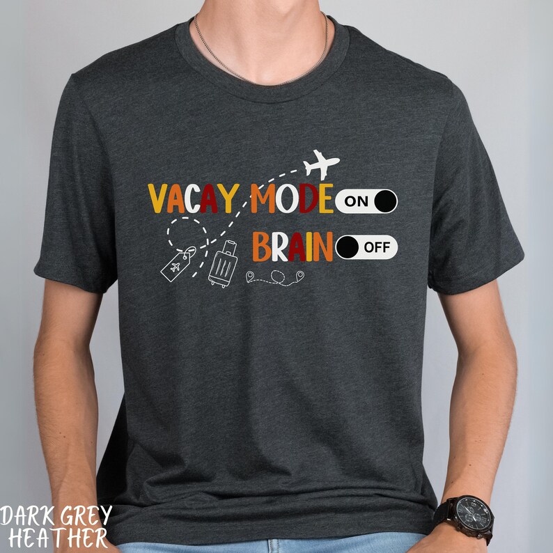 May include: Dark grey heather t-shirt with the text "Vacay Mode On" and "Brain Off" with a plane, suitcase, and toggle switch graphic.