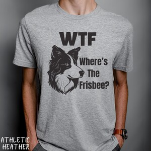 May include: A gray t-shirt with a black and white illustration of a border collie dog. The text "WTF Where's The Frisbee?" is printed on the shirt.