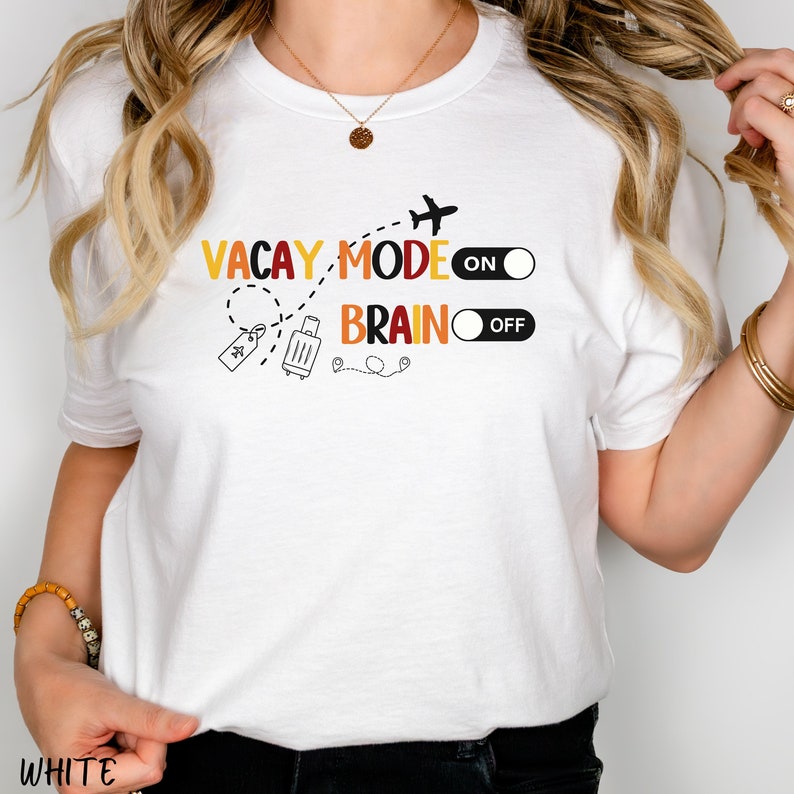 May include: White t-shirt with a graphic design that says "Vacay Mode On" and "Brain Off" with a suitcase, aeroplane, and toggle switches.