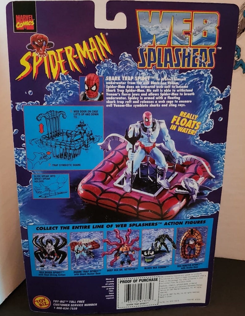 May include: A Spider-Man Web Splashers action figure, packaged on a purple and blue background. The figure is on a red raft, with the words "Web Splashers" and "Spider-Man" prominently displayed. The packaging includes text describing the figure's features.