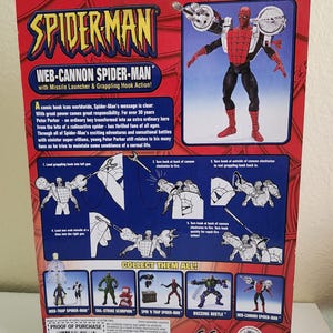 May include: A red and blue Spider-Man action figure with a web cannon on his arm. The figure is holding a grappling hook and a missile launcher. The packaging includes instructions on how to use the figure's features. Collect them all!  Web-Cannon Spider-Man, Web-Trap Spider-Man, Tail-Strike Scorpion, Spin 'N Trap Spider-Man, Buzzing Beetle.