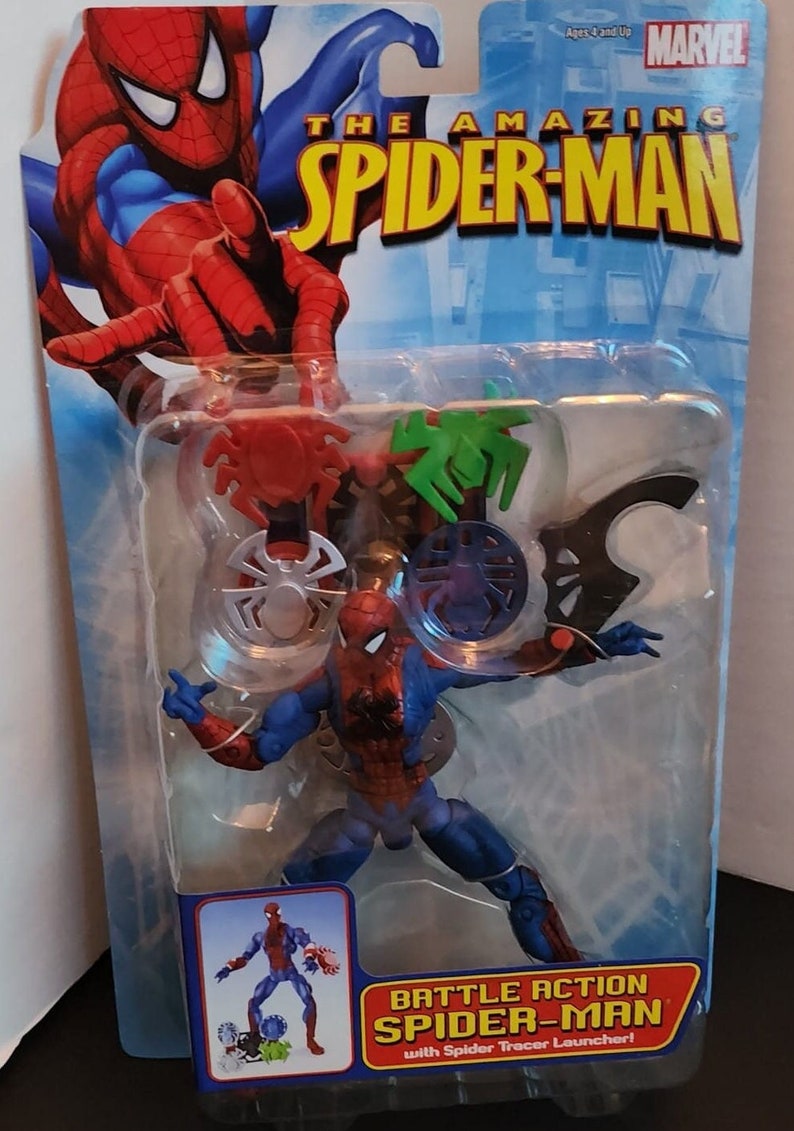 May include: A plastic action figure of Spider-Man in a red and blue suit with a web shooter in his right hand. The figure is packaged in a plastic blister pack with a blue background and the words "The Amazing Spider-Man" in yellow letters. The package also includes a red and green spider web launcher.