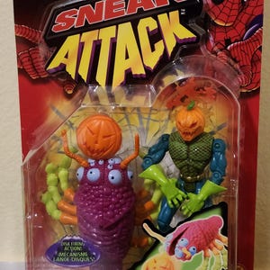 May include: Spider-Man "Sneak Attack" Bug Busters action figure set. The set includes two figures: Jack O'Lantern and a purple bug-like creature. The packaging features Spider-Man graphics and text that reads "Disk Firing Action!" and "Bug Busters".