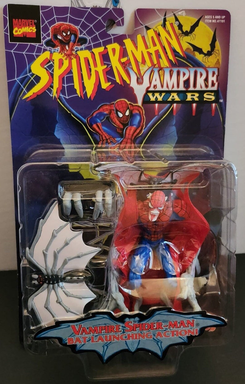 May include: A plastic package containing a red and blue action figure of Spider-Man with bat wings. The figure is labeled "Vampire Spider-Man" and "Bat Launching Action!" The package also includes a white bat with a black spider on it.