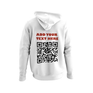May include: White hooded sweatshirt featuring the text "ADD YOUR TEXT HERE" in red above a black QR code. The back view highlights the hood and printed design. A casual, customisable apparel item.