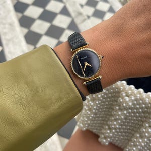 Vintage 1980s Swiss Gold Plated Round Bezel Minimalist Black Dial Manual Wind Up Black Leather Strap Ladies Dress Wristwatch By Accurist