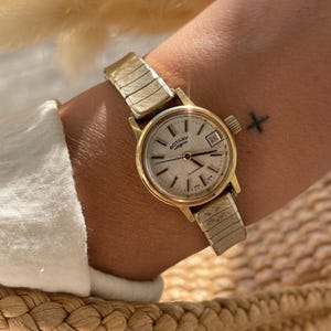 Vintage 1970s Automatic Swiss Made Manual Wind Up Round Rolled Gold Case Ladies Wristwatch With Gold Stretchy Strap, Date Sub Dial By Rotary