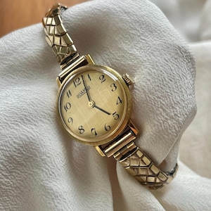 Vintage 1970s Chic Wind Up Rolled Gold Plated Round Dial Ladies Dress Cocktail Wristwatch With Dainty Gold Stretchy Strap By Roamer