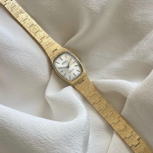 Vintage 1970s 17 Jewels Swiss Incabloc Brushed Gold Plated Wind Up Mechanical Ladies Cocktail Wristwatch By Montine Of Switzerland.