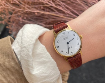 Vintage 1980s Gold Plated Swiss 17 Jewels Incabloc Manual Wind Up Brown Leather Strap Large Round White Dial Ladies Wristwatch By Oriosa