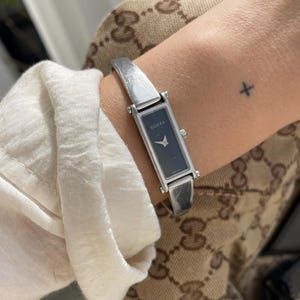 Vintage 90s/00s Gucci St. Steel 1500L Black Dial Rectangular Tank Style Dial Swiss Quartz Dainty Ladies Horsebit Bangle Wristwatch