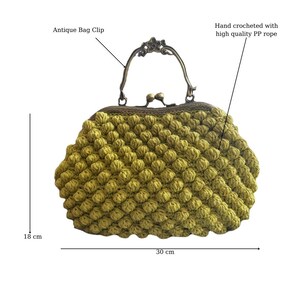 May include: A yellow crocheted handbag with a vintage-style clasp and handle. The bag measures 18 inches tall and 30 inches wide.