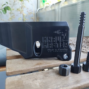 Puede incluir: Una pieza de pl&aacute;stico negro impresa en 3D con el texto "KNIGHTMARE MAKER" y "Made in Croatia". La pieza viene acompa&ntilde;ada de tres tornillos de pl&aacute;stico negro.