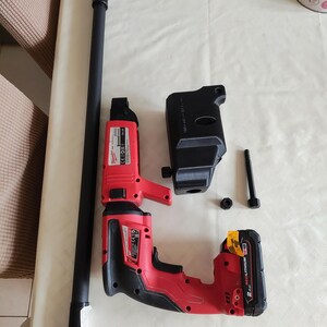 Puede incluir: Un taladro inal&aacute;mbrico rojo y negro con una bater&iacute;a negra y una varilla de extensi&oacute;n negra larga. El taladro tiene un gatillo negro y rojo y un mango negro. La bater&iacute;a tiene el texto "2.0Ah REDLITHIUM" en ella.