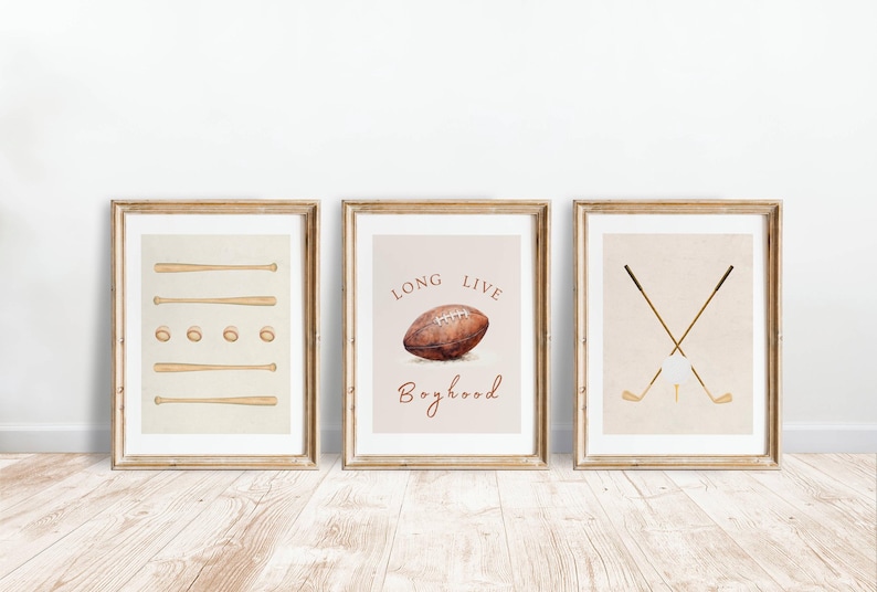 May include: Three framed prints with a sports theme. The first print features a baseball bat and ball design. The second print features a football with the text "Long Live Boyhood". The third print features two crossed golf clubs with a golf ball.