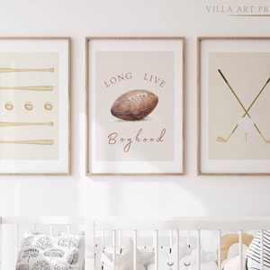 May include: Three framed prints with a sports theme. The first print features a set of baseball bats, the second print features a football with the text "Long Live Boyhood", and the third print features two crossed golf clubs.