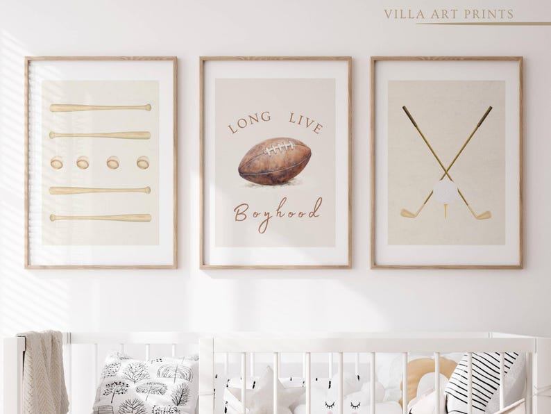 May include: Three framed prints with a sports theme. The first print features a set of baseball bats, the second print features a football with the text "Long Live Boyhood", and the third print features two crossed golf clubs.