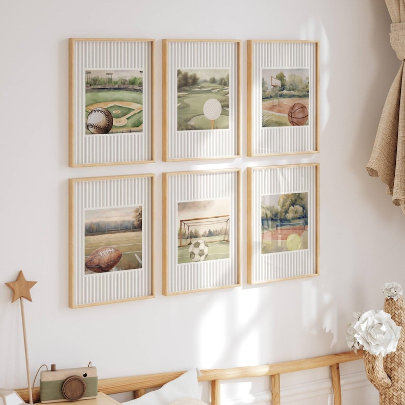 May include: Six framed watercolor prints featuring sports themes. The prints depict a baseball field with a baseball, a golf course with a golf ball, a basketball court with a basketball, a football field with a football, a soccer field with a soccer ball, and a tennis court with tennis balls.