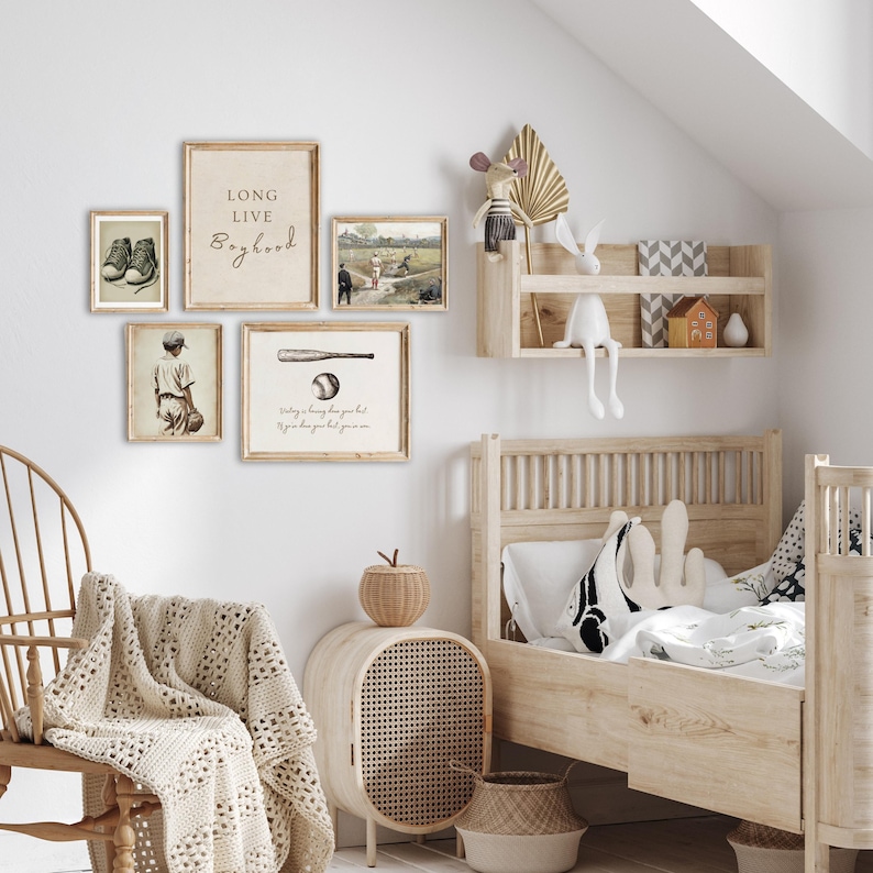 May include: A nursery room with a wooden bed, a rocking chair, and a shelf with various decorative items. The walls are decorated with framed prints featuring baseball-themed illustrations and quotes, including "Long Live Boyhood" and "Swinging for the fences but you gotta know you got 'em".