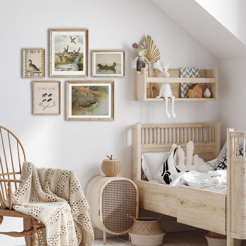 May include: A light wood framed bed with a white and black patterned pillow and a white blanket. There are several framed prints on the wall behind the bed, including one with the text "Long Live Bigfoot".