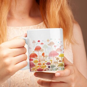 May include: White ceramic mug with a colorful mushroom design. The mushrooms are in various shades of red, orange, yellow, green, blue, and purple.