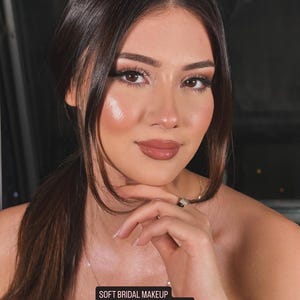 May include: A woman with soft bridal makeup, including a natural lip colour and highlighted cheekbones. The image includes text that reads "SOFT BRIDAL MAKEUP Video Tutorial + Step by Step Guide" and "Digital Download."