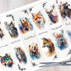 May include: A sheet of paper with 12 watercolor bookmarks featuring various animals, including a wolf, owl, bear, fox, deer, and eagle. The bookmarks are printed on white paper with black ink and have a watercolor effect.