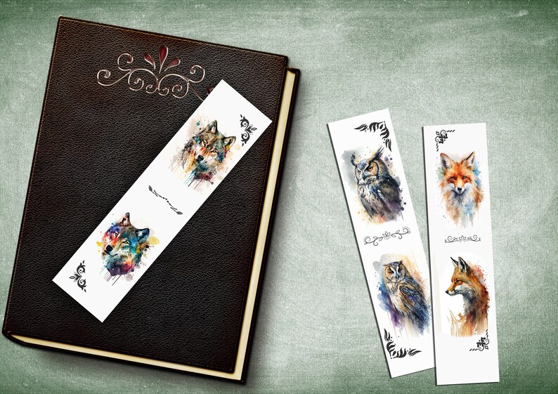 May include: Four watercolor bookmarks featuring a wolf, an owl, and a fox. The bookmarks are white with black decorative borders. The wolf is blue, green, and purple. The owl is brown, gray, and white. The fox is orange, white, and brown.