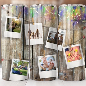 May include: A stainless steel tumbler with a woodgrain design and multiple photos of families hanging from a string with clothespins. The photos are in a vintage style with white borders. The tumbler has a seamless design.